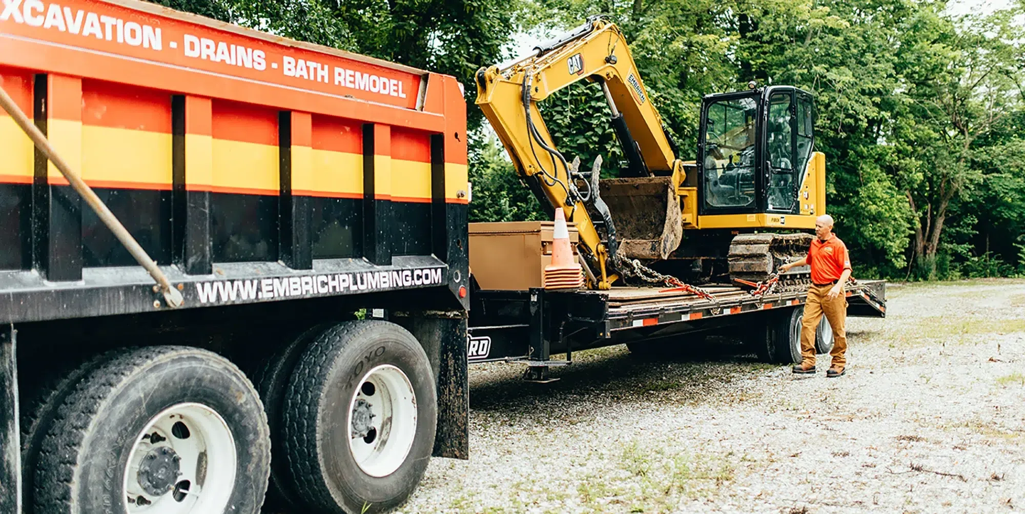 Heavy construction equipment and dump truck used by Embrich Plumbing, Heating & Air Conditioning for excavation and sewer services in Collinsville