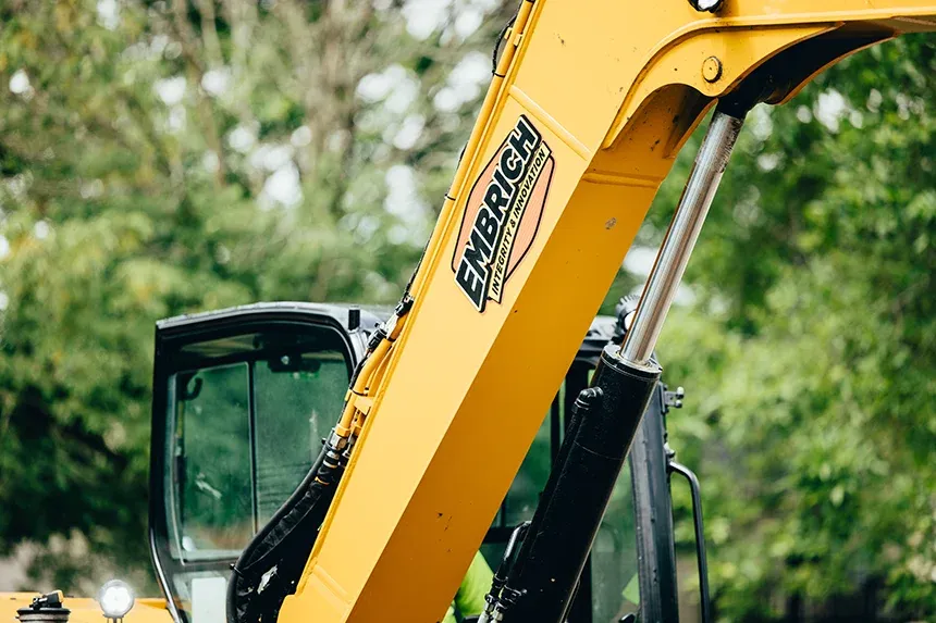 Excavator used by Embrich Plumbing, Heating & Air Conditioning for underground plumbing and sewer line work in Collinsville