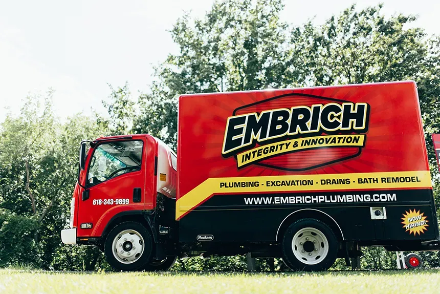 Embrich Plumbing, Heating & Air Conditioning branded service truck parked at residential plumbing job in Collinsville