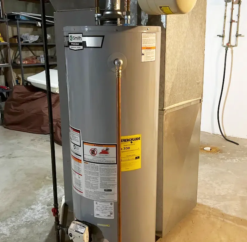 New A.O. Smith ProLine gas water heater installed in basement by Embrich Plumbing, replacing old unit with energy efficient model