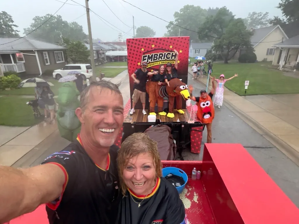 Embrich team members taking a selfie in front of the Toy Story float at the Maryville Fireman’s Picnic Parade
