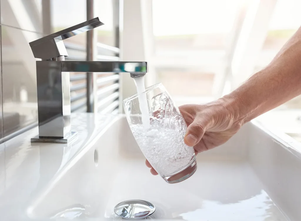 person filling a cup of clean, filtered water in their bathroom collinsville illinois