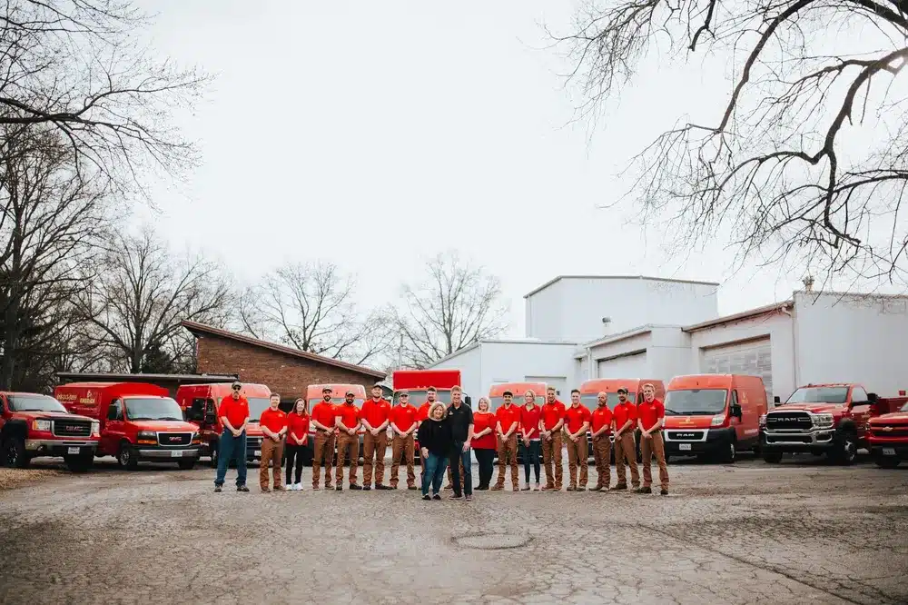 Full Embrich Plumbing, Heating & Air Conditioning crew standing together outside company facility