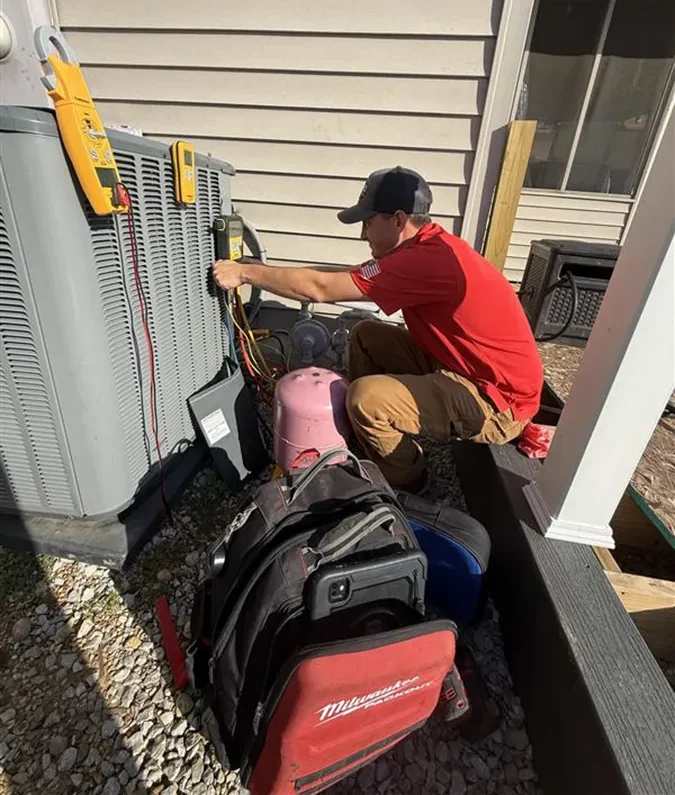 Embrich service expert working on heat pump