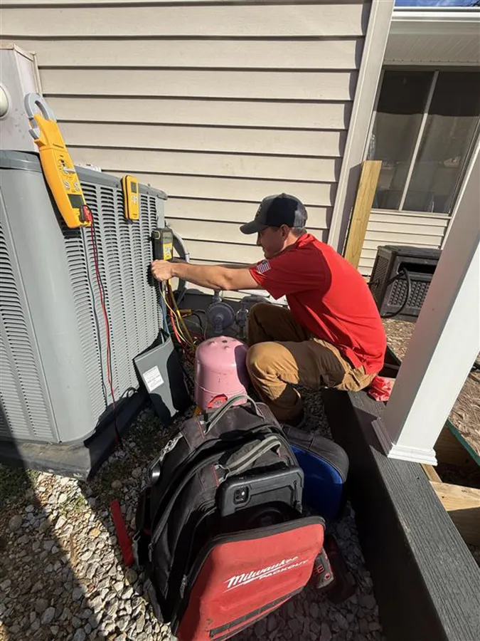 Embrich service expert working on heat pump