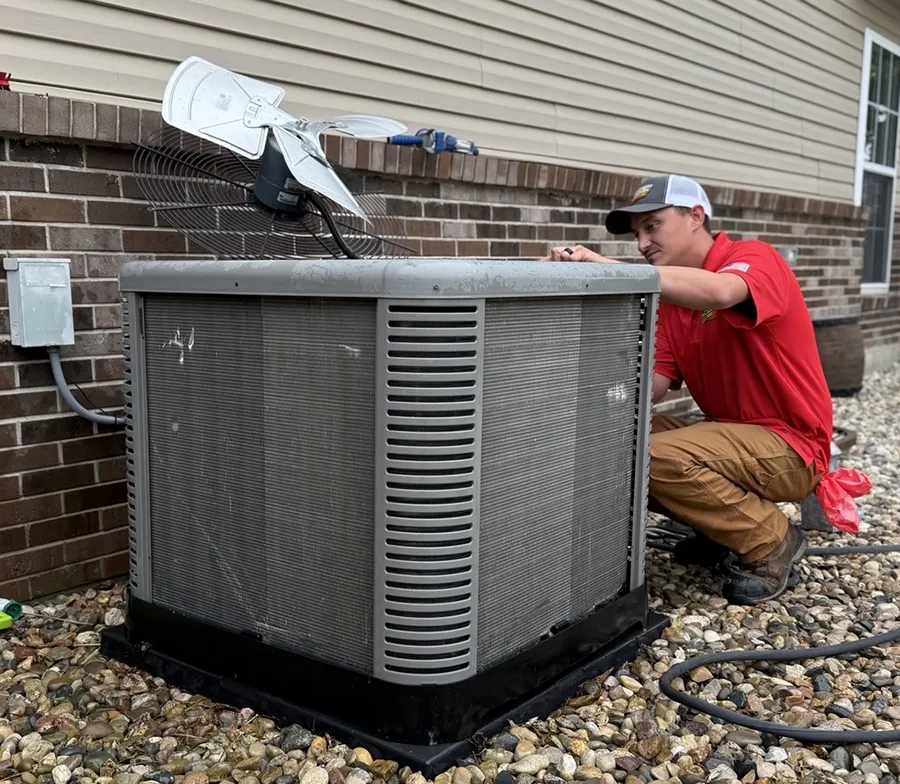 Embrich service expert working on heat pump