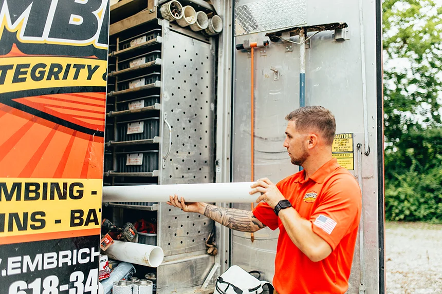 Embrich Plumbing, Heating & Air Conditioning service expert getting piping from service truck in Collinsville