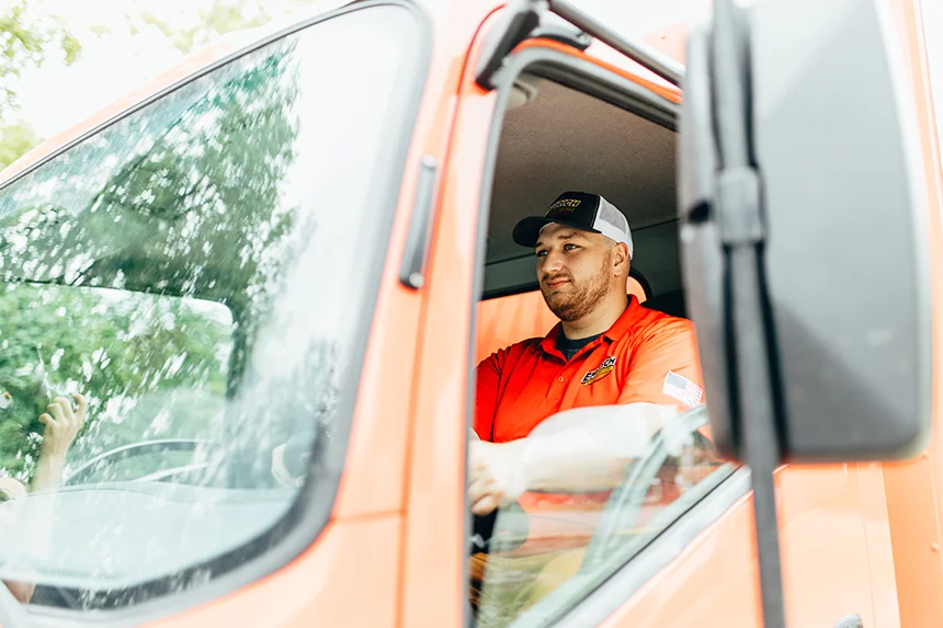 Embrich Plumbing, Heating & Air Conditioning service expert exiting service truck for plumbing repair service in Collinsville