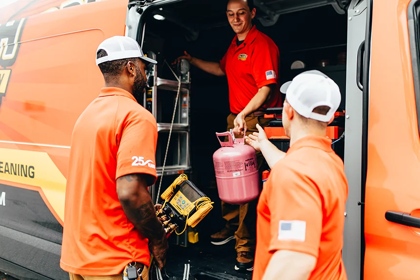 Embrich Plumbing, Heating & Air Conditioning service experts preparing plumbing tools and equipment from service vehicle in Collinsville