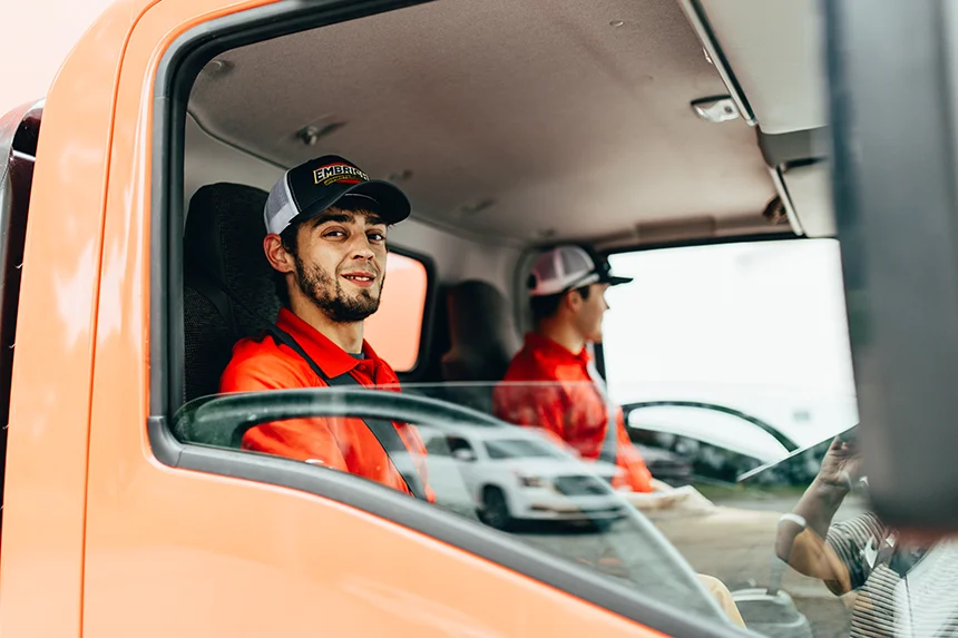 Friendly Embrich Plumbing, Heating & Air Conditioning service expert sitting in company service van ready for a job in Collinsville