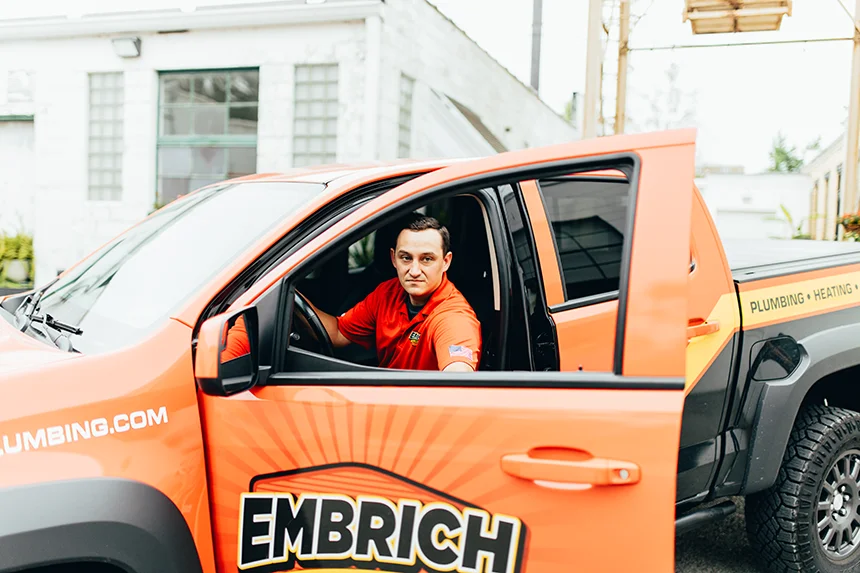 Embrich Plumbing, Heating & Air Conditioning service expert seated in branded plumbing service vehicle in Collinsville