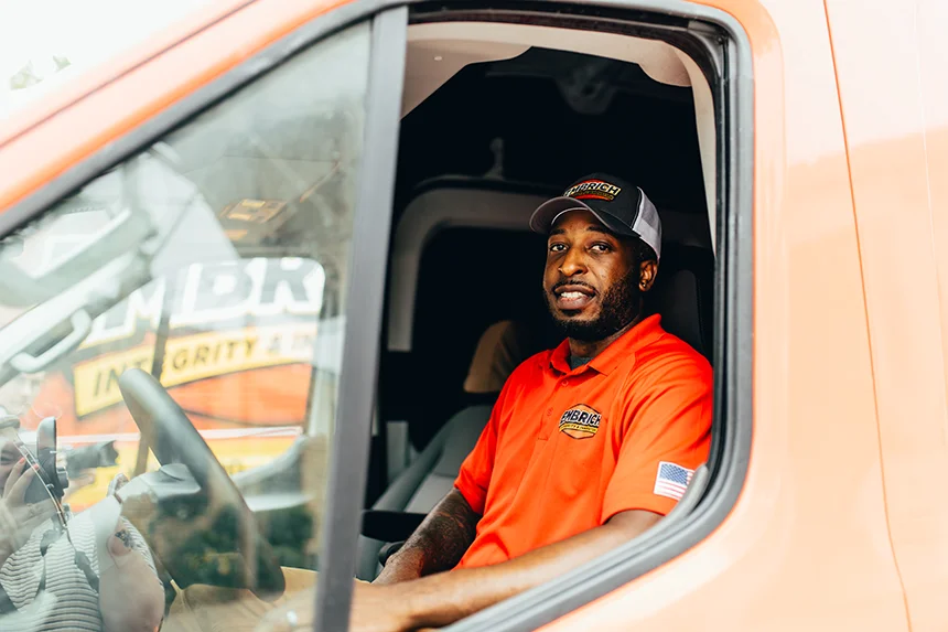 Embrich Plumbing, Heating & Air Conditioning service expert inside service truck preparing for plumbing service call in Collinsville