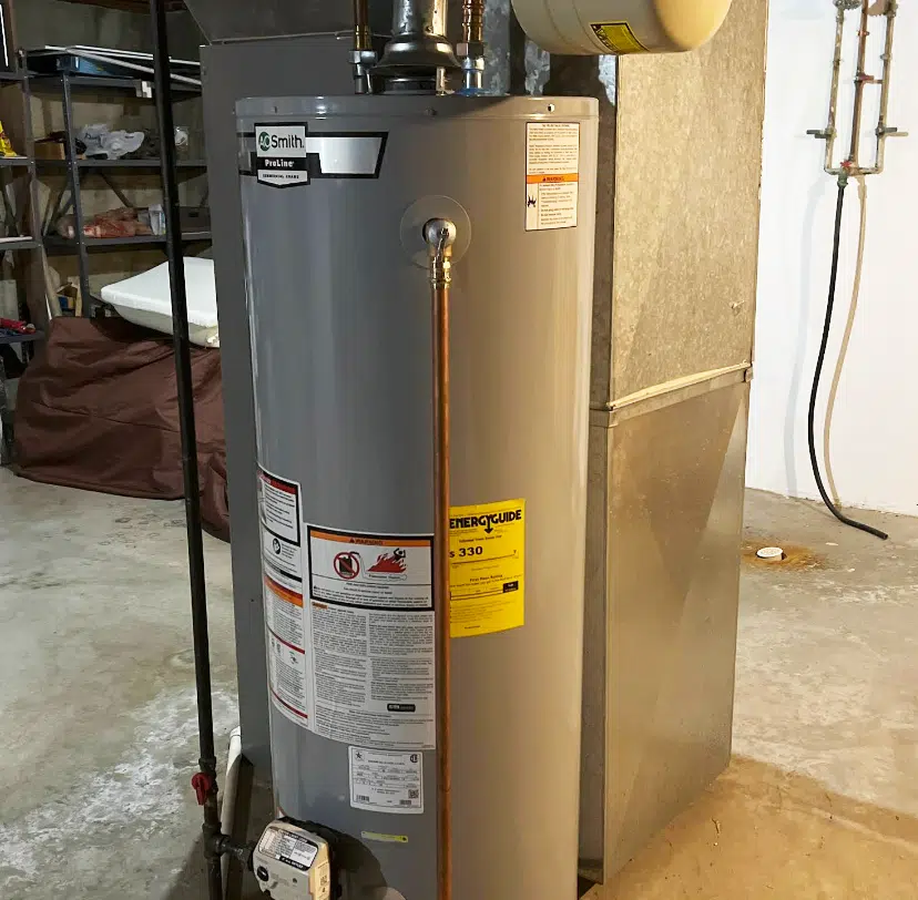 New A.O. Smith ProLine gas water heater installed in basement by Embrich Plumbing, replacing old unit with energy efficient model