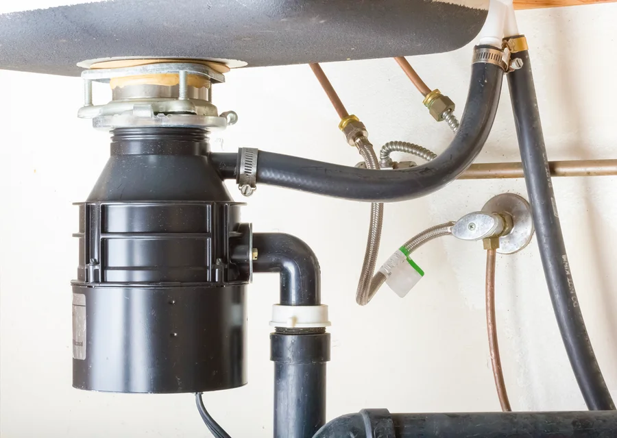 Garbage disposal repair under kitchen sink – Embrich Plumbing